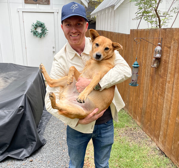 Dan Jermy with a dog in his arms